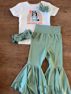 Our Bluey Birthday outfit is so cute. This top will match most of our bell bottoms. This outfit is perfect for a shower girt or any birthday. We can't wait to see what combo you purchase. Don't forget we have a matching Mama and Daddy top too! just to make this birthday even more special.  Too is 100% cotton Content: 96% Polyester & 4% Spandex Care: Machine Wash, Cold; Tumble Dry, Low; Use Cool Iron. This item is not our own design. We can not change or alter in anyway. | Please do not leave chi Fun Birthday Sets For Spring, Cute Cotton Party Sets, Cute Summer Bottoms For Birthday, Cute Birthday Sets For Spring, Cute Spring Birthday Sets, Bluey Birthday Outfit, Bell Bottoms Outfit, Bluey Birthday, Bell Pants