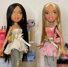 two dolls are standing next to each other