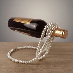 a wine bottle with pearls attached to it