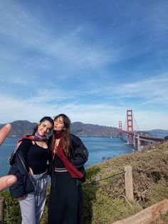 two women taking a selfie with the golden gate bridge in the backgroud