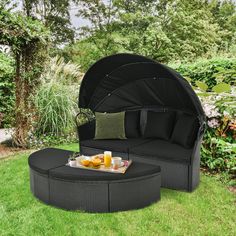 an outdoor couch and table in the grass