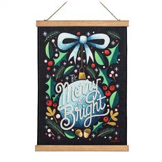 a christmas card hanging on a wall with the words merry and bright written in it