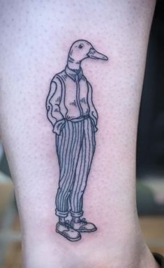 a small tattoo of a duck wearing a suit and tie