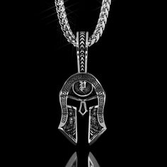 This half polished and half battle-worn Spartan Helmet is a symbol of Strength, Courage, Loyalty, and Power. The Silver Spartan Pendant was created for Free Men who demand the most of themselves. our Men's silver Spartan Pendant is designed, sculpted and handcrafted in the USA. Silver weight is 20. The Helmet itself measures 32mm (1.25 inches) in length and 21mm (0.82 inches) in width. The overall length, including the bail (Crest of the Helmet), is 52mm (2 inches). *Other sizes available upon r Warrior Style Silver Stainless Steel Jewelry, Warrior Style Engraved Pendant Jewelry, Silver Stainless Steel Warrior Jewelry, Engraved Warrior Style Pendant Jewelry, Silver Engraved Warrior Necklace, Warrior Style Engraved Sterling Silver Jewelry, Silver Warrior Style Necklace For Gift, Mens Silver Pendants, Pendants For Men