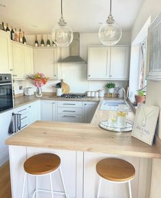 a kitchen with two stools at the island