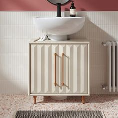 a white sink sitting under a mirror next to a radiator