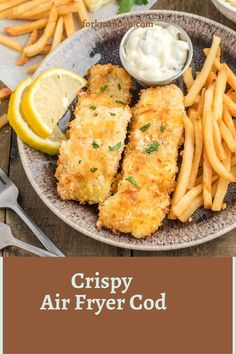 crispy air fryer food served on a plate with fries and lemon wedges