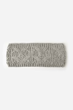 a knitted headband with an intricate design on the front and side, in light grey