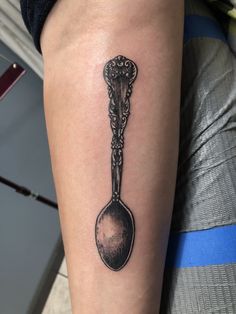 a black and white photo of a spoon tattoo