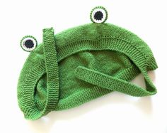 a green knitted hat with eyes on it