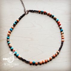 Bring boho vibes anywhere with this colorful beaded necklace! This handmade beaded necklace features a combination of multi-colored beads, wood beads, and copper beads. Worn at the collar bone, this colorful beaded necklace is great for layering with long turquoise necklaces or worn alone as a statement piece. An extender chain and lobster claw clasp make this boho beaded necklace easy to wear. Although this handmade beaded necklace will resemble the photo, no two pieces of our handmade beaded j Rustic Adjustable Beaded Necklace, Rustic Adjustable Beaded Necklaces For Festivals, Rustic Beaded Necklace For Festivals, Bohemian Heishi Bead Necklace With Wooden Details, Bohemian Necklace With Wooden Heishi Beads, Orange Beaded Bohemian Choker, Bohemian Brown Beaded Choker, Orange Bohemian Beaded Choker, Bohemian Orange Beaded Choker