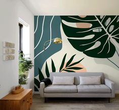 a living room with a couch and wall mural