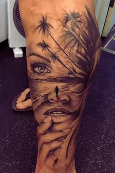 a woman's leg with tattoos and palm trees on it