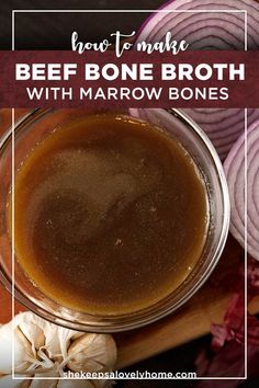 a bowl filled with beef bone broth next to onions and garlic on a cutting board