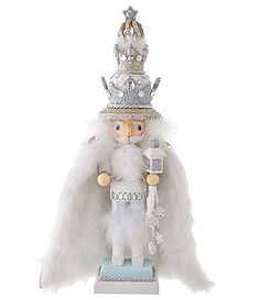 a white and silver figurine with a crown on top