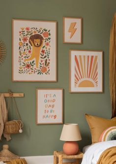 a bedroom with green walls and pictures on the wall