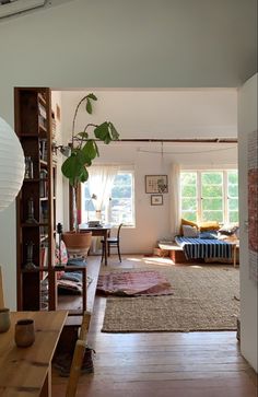 a living room filled with furniture and a book shelf