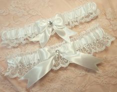 "Handcrafted wedding garter set. Created w/ white satin and white lace. Centered w/ white satin bow and clear rhinestone. Garters stretch comfortably up to and at 22\". Personalization is available for an additional fee. Please leave the names and date in the box provided. If you would like a personalized ribbon for BOTH garters, please choose the personalized option in the drop down menu for your main garter, then add this to your purchase for the second garter... https://www.etsy.com/shop/Gart Adjustable White Bridal Accessories For Bridal Shower, Wedding Garder, Cow Halloween Costume, Victorian Sleeves, White Garter Belt, Sleeve Garter, Leg Garters, Clothing Board, White Garters