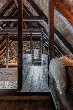 an attic with wood floors and wooden beams