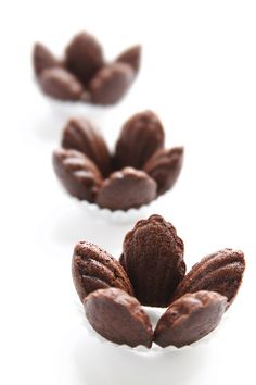 three pieces of chocolate sitting on top of each other in front of a white background