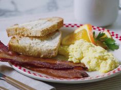 a plate with eggs, bacon and toast on it