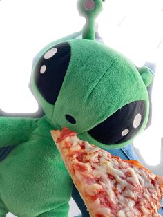 a stuffed animal holding a slice of pizza