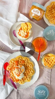 some waffles are sitting on plates with sauce