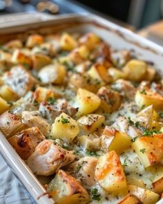 a casserole dish with chicken, potatoes and cheese