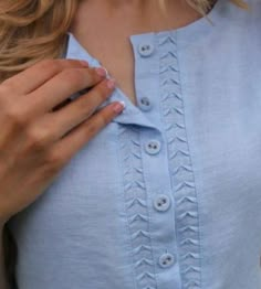 a woman wearing a blue shirt and holding her hand on her chest with the words visual search below it