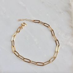 "This beautiful gold paperclip link chain bracelet is a staple for everyday wear. It is sure to be your favorite bracelet, both dainty, adjustable, and lightweight. The perfect little layering bracelet. It includes an adjustable extender in 1\" length so you never have to worry about ordering the wrong size. DETAILS - 24K gold plated - Made with Love - Gift Box Included PRODUCTION ∙ TIMES All items are made to order. Please check the current production time before shipping. If you need it sooner Bridesmaid Rings, Gold Chain Bracelet, Gold Link Bracelet, Letter Ring, Link Chain Bracelet, Gold Link, Initial Ring, Gold Paper, Minimalist Bracelet