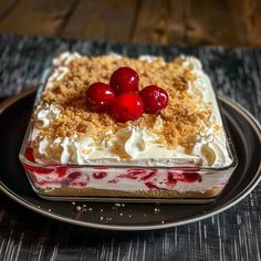 a cake with cherries on top and crumbs in the middle is sitting on a plate