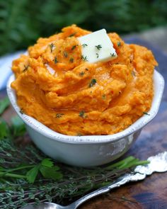 a white bowl filled with mashed sweet potatoes