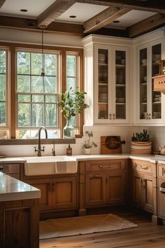 a kitchen filled with lots of wooden cabinets and counter top space next to a window