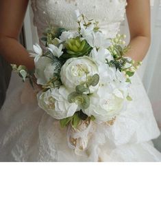 a bride holding a bouquet of white flowers