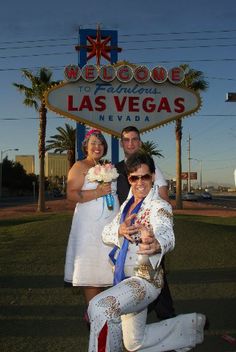 the bride and groom are posing in front of the las vegas wedding sign with their bridal couple