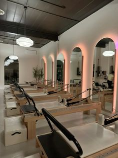 an empty gym with rows of benches and mirrors