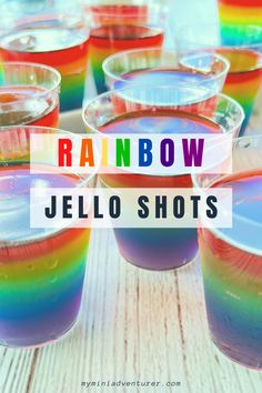 rainbow jello shots in plastic cups with the words rainbow jello shots on top