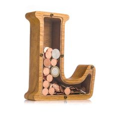 the letter j is made out of wood and has coins in it