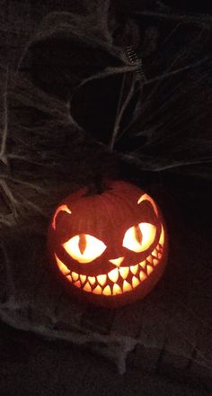 a carved pumpkin with glowing eyes on it