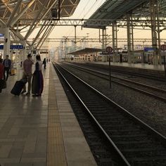 several people are waiting at the train station