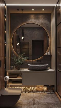 a bathroom with a round mirror above the sink and a bathtub next to it