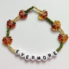 a beaded bracelet with leaves and the word everyone written on it in white letters