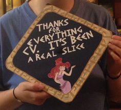 a woman holding up a sign that says thanks for everything ever it's been