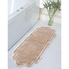 a bath mat sitting on top of a bathroom floor