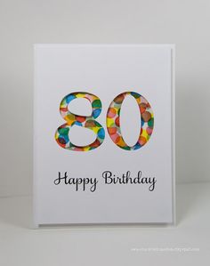 a birthday card with the number 80 on it's front and colorful confetti in the middle