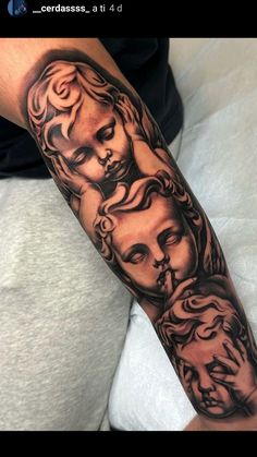 a man with a tattoo on his arm that has three faces and two heads in it