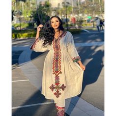 This fashionable Fetil Habesha dress is the perfect combination of traditional and modern style. The Shimena cut flatters your curves and adds a touch of elegance to the design, while the intricate Fetil embroidery on the neckline and sleeves is a true work of art, showcasing the skill and craftsmanship of Ethiopian artisans. The dress is made from high-quality fabric that feels soft and comfortable against the skin, while the modern design gives it a fresh, contemporary feel. The vibrant colors Beige Dress For Navratri Festival, Folk Style Fitted Dress For Eid, Fitted Folk Dress For Eid, Traditional Tunic Dresses For Navratri, Traditional V-neck Dress With Dabka Detailing, Traditional V-neck Dabka Dress, Beige Resham Embroidered Festival Dress, Traditional Beige Dresses For Eid, Traditional Beige Dress For Festive Occasions