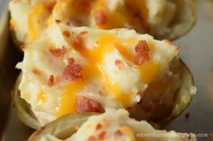 some potato shells with cheese and bacon on them