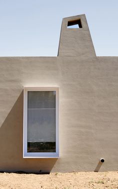 a small window in the side of a building with a skylight on it's roof