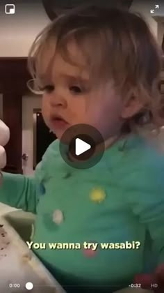 a baby is playing with an object in the living room